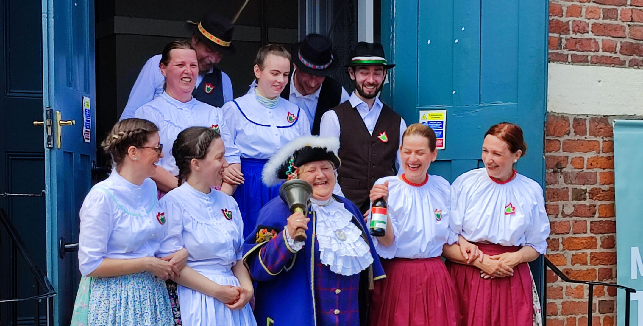 Hungarian dancers celebrating with a Welsh town crier in Montgomery